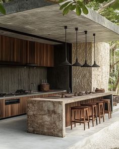 an outdoor kitchen with bar stools next to it