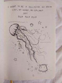 an open notebook with a drawing of a jellyfish