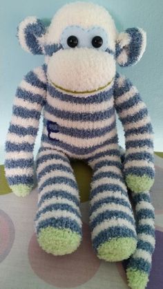 there is a stuffed monkey that has stripes on it's body and eyes,