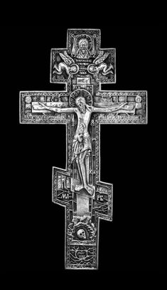 an ornate cross with the crucifix on it's side, in black and white