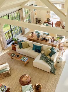 an overhead view of a living room with couches and tables in the middle of it