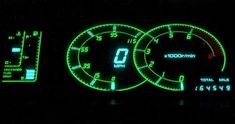 the instrument gauges are glowing green and yellow in this photo, it is dark