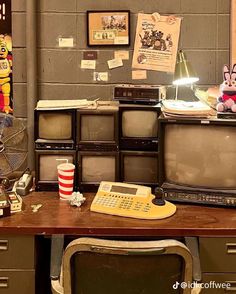 an old fashioned television set sitting on top of a wooden desk