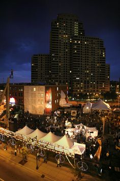 tents set up in the middle of a city at night