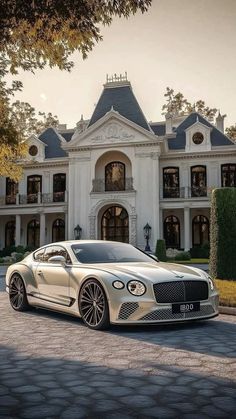 a white car parked in front of a large house