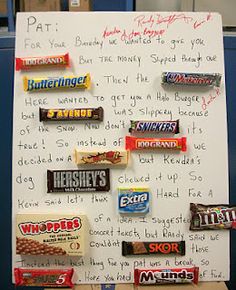 a white board with writing on it and candy bars attached to the back of it
