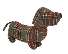 a stuffed dog is wearing a red and gray checkered coat on it's back