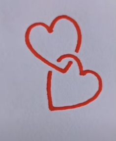 a drawing of a red heart with a knot in the middle