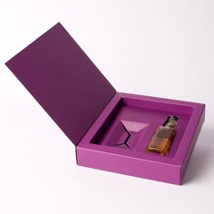 an open purple box with a bottle in it