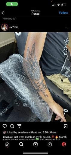 a man with a tattoo on his arm sitting in a chair