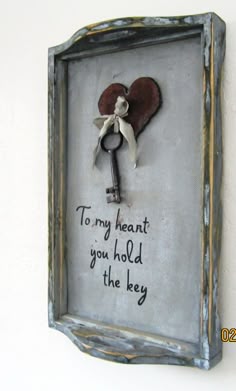 an old key hangs on the wall with a message in it that reads, to my heart you hold the key