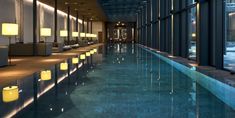 an indoor swimming pool with lights on the sides