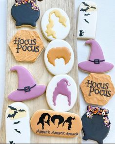 decorated cookies with witches and hockies on a wooden board for trick or treat