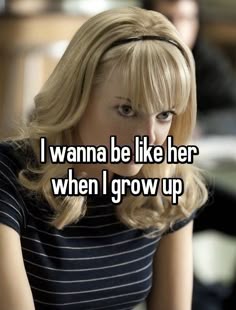 a woman with blonde hair sitting down and looking at the camera