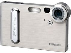 a silver digital camera sitting on top of a white surface