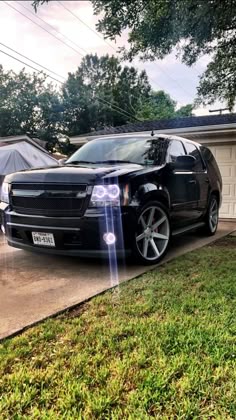 a black car parked in front of a house