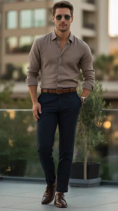 Warm, flattering and strangely adorable this is the sort of semi formal front that has to work hard and that does not seem to. Soft taupe button down beset to cabriolet dyed navy trousers, held together by deep brown der sols and to match a dyed-matching belt. Minimalist, but so effective. Male Business Casual, Office Outfit Mens, Business Attire Men Professional, Wedding Guest Outfit Mens, Mens Business, Men Fall Business Casual, Professional Outfits For Men, Formal Mens Fashion Classy, Timeless Semi-formal Shirt With Buttons