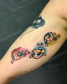 cartoon tattoos on the arm of a person