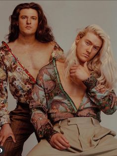 two people posing for a photo with one woman wearing a shirt and the other man in khaki pants