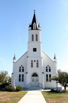 a white church with a steeple on the top