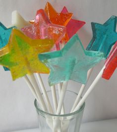 colorful star shaped lollipop sticks in a glass