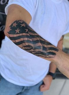 a man's arm with an american flag tattoo on it