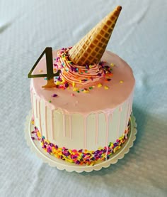 a birthday cake with an ice cream cone on top