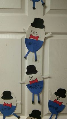 the door is decorated with paper cutouts and some hats on top of each other