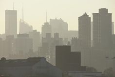 the city skyline is covered in smoggy haze
