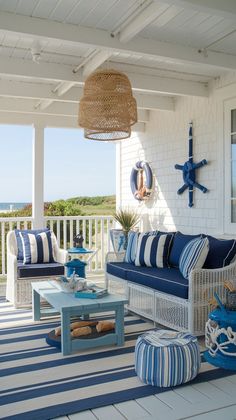 an outdoor living room with blue and white furniture