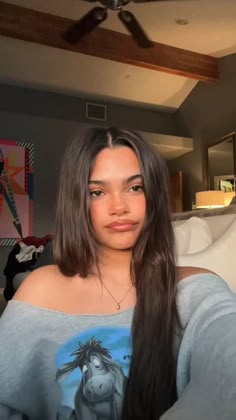 a woman with long hair is taking a selfie