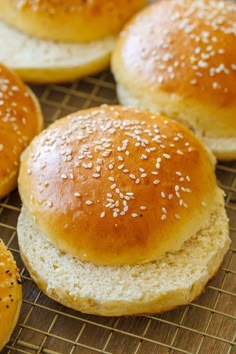 sesame seed buns on a cooling rack ready to be baked