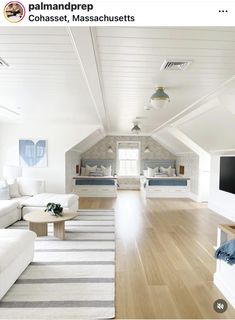 a living room with white furniture and wood flooring in an attic style home on instagram