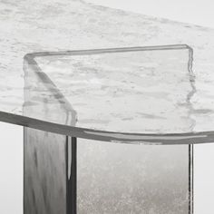 an oval glass table with metal legs in black and white