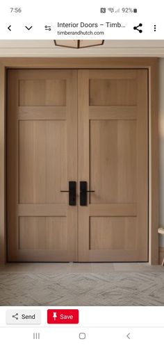 two wooden doors in the middle of a room with white walls and beige carpeting