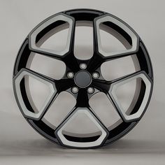 a black and silver wheel on a gray background