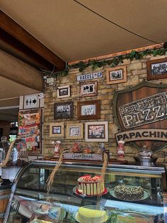 there is a wall with pictures on it and a cake in the foreground that says papachin