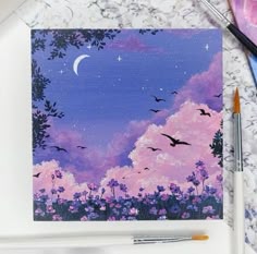 a painting with some paintbrushes next to it on a white surface and two birds flying in the sky