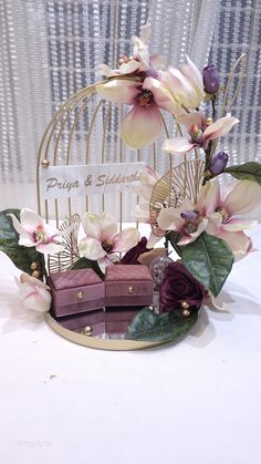 there is a birdcage with flowers in it