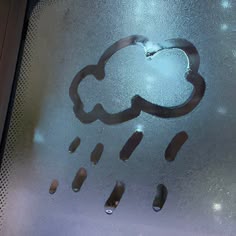 there is a cloud and rain drawn on the glass