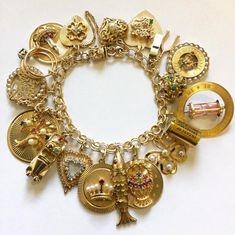 Fine Jewelry Gold Charm Bracelet With 17 Jewels, Gold Charm Bracelet With 17 Jewels In 14k Gold, Chunky Gold Charm Bracelet, Vintage Gold Charm Bracelet Gift, Luxury Gold Plated Charm Bracelet With 17 Jewels, Vintage Gold Sterling Silver Charm Bracelet, Gold-tone Chunky Chain Charm Bracelet As Gift, Vintage Charm Bracelet With Various Charms, Colorful Vintage Charm Bracelet