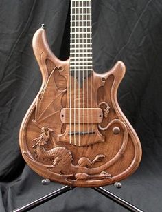 an intricately carved wooden guitar sits on a stand