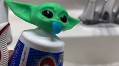 a toothbrush holder with an infant yoda on it