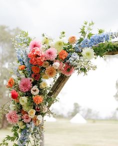 an arch decorated with flowers and greenery