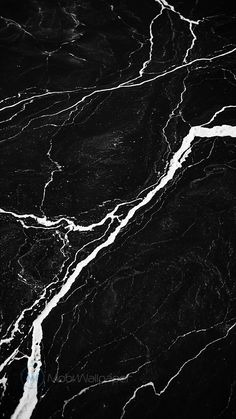 black and white marble textured wallpaper with water flowing down the center, in an abstract pattern