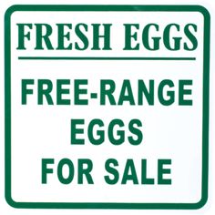 a green and white sign that says fresh eggs free range eggs for sale on it