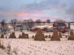 a snow covered field with trees and houses in the background