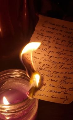 a candle with a handwritten note on it