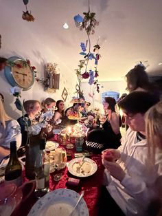 a group of people sitting around a table eating food