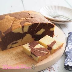 a loaf of cake sitting on top of a wooden cutting board